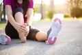 Young woman massaging her painful foot while exercising. Running Sport and excercise injury concept Royalty Free Stock Photo