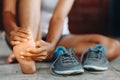 Young woman massaging her painful foot from exercising and running Sport and exercise concept. Royalty Free Stock Photo