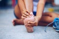 Young woman massaging her painful foot from exercising Royalty Free Stock Photo