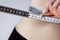 Young woman measures her waist with a measuring tape, beautiful figure, sports, massage and diet for weight loss Royalty Free Stock Photo