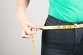 young woman measures her waist with a tape Royalty Free Stock Photo