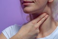 A young woman measures the pulse on her neck