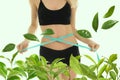 Young woman measuring her waist on light background, closeup. Tea leaves for slimming drink Royalty Free Stock Photo
