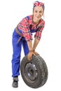 Young woman mechanic with a car wheel Royalty Free Stock Photo