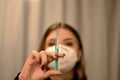 Young woman in a medical mask  with a needle in her hand Royalty Free Stock Photo