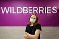 young woman in medical mask shopping sign Wildberries international online store Royalty Free Stock Photo