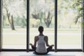 Young woman meditate at home, Girl practicing yoga near floor window in yoga studio, Relaxation, body care concept