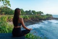 A young woman meditates by the sea Royalty Free Stock Photo