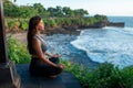 A young woman meditates by the sea Royalty Free Stock Photo