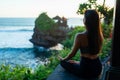 A young woman meditates by the sea Royalty Free Stock Photo