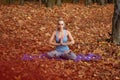 Young woman meditating in autumn forest Royalty Free Stock Photo