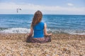 Young woman meditating on the beach Royalty Free Stock Photo