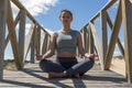 Young woman meditating on the catwalk under the sun Royalty Free Stock Photo