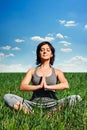 Young woman meditating on the field Royalty Free Stock Photo