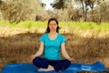 Young woman meditating in the forest, relaxation yoga poses for a healthy lifestyle.