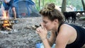 Young woman meditating with Kali mudra hands yoga pose while camping in the forest