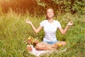 Young woman meditating in lotus position while doing yoga in a wonderful forest. Travel, Healthy Lifestyle concept Royalty Free Stock Photo