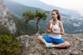 Young woman meditating outdoors, girl doing yoga high in the mountains, relaxation self-reflection concept Royalty Free Stock Photo