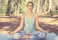 Young woman meditating outdoors in spring summer park Royalty Free Stock Photo