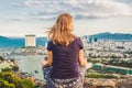 Young woman meditating over ancient city landscape on sunrise Copy space Royalty Free Stock Photo