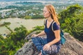Young woman meditating over ancient city landscape on sunrise Copy space Royalty Free Stock Photo