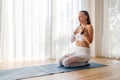 Young woman meditating and practicing yoga breathing exercise during her morning yoga routine Royalty Free Stock Photo