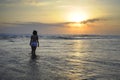 Young woman meditating and thinking peacefully on desert beach on sunset in meditation and freedom Royalty Free Stock Photo