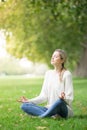 Young woman meditating and Yoga in a park