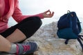 young woman meditation in a yoga pose at the beach. girl in lotus position on an empty stone seashore. takes yoga, sports, Royalty Free Stock Photo