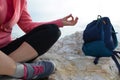 young woman meditation in a yoga pose at the beach. girl in lotus position on an empty stone seashore. takes yoga, sports,