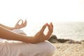 Young woman meditation in a yoga pose on the tropical beach. Royalty Free Stock Photo