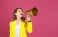 Young woman with megaphone on background