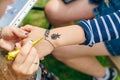 young woman mehendi artist painting henna on the hand Royalty Free Stock Photo