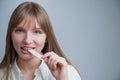 Young woman with metal braces on her teeth is chewing gum. Copy space. Royalty Free Stock Photo