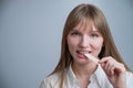 Young woman with metal braces on her teeth is chewing gum. Copy space. Royalty Free Stock Photo