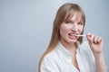 Young woman with metal braces on her teeth is chewing gum. Copy space. Royalty Free Stock Photo