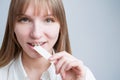 Young woman with metal braces on her teeth is chewing gum. The girl is eating gummy candy Royalty Free Stock Photo