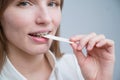 Young woman with metal braces on her teeth is chewing gum. The girl is eating gummy candy Royalty Free Stock Photo