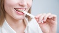 Young woman with metal braces on her teeth is chewing gum. The girl is eating gummy candy Royalty Free Stock Photo