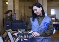 Young woman in military medic uniform showing content of an individual first aid kit Royalty Free Stock Photo