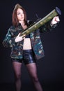 Young woman in the military uniform with the bazooka