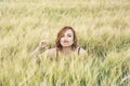 Young woman mimics mustache in the wheat field