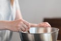 Young woman mixing chocolate in steel bowl to make candys Royalty Free Stock Photo