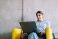 Young woman mobile developer with laptop, writes program code on a computer, programmer work in modern office