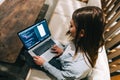 Young woman mobile developer with laptop, writes program code on a computer, programmer work in modern office