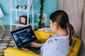 Young woman mobile developer with laptop, writes program code on a computer, programmer work in modern office