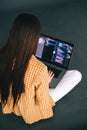 Young woman mobile developer writes program code on a computer, programmer work