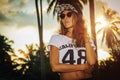 Young woman model in baseball cap and in sunglasses on the sunset backround Royalty Free Stock Photo