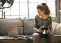 Young woman with modern dslr camera using laptop Royalty Free Stock Photo