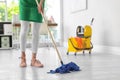 Young woman with mop cleaning floor Royalty Free Stock Photo